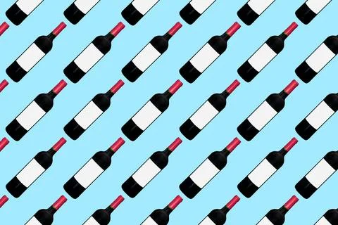 Pattern of wine bottles on blue background. Pattern for winery or liquor stor Stock Photos