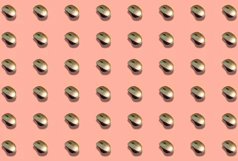 A pattern with a wireless computer mouse on a pink background. Stock Photos