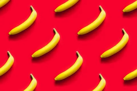 Pattern of yellow bananas on a red background. Stock Photos