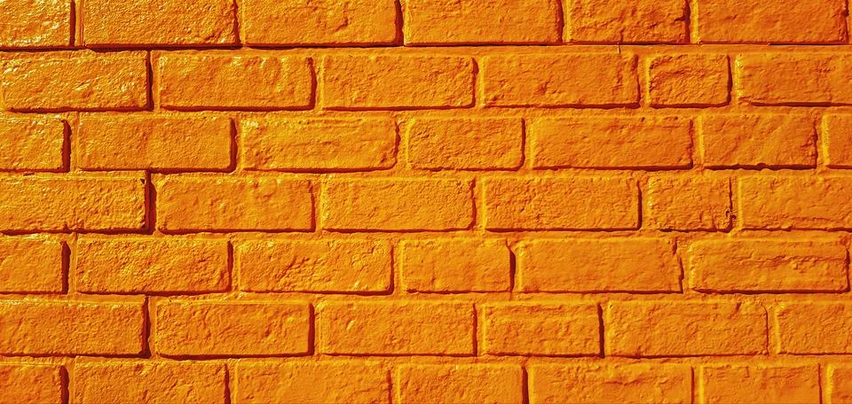 Pattern yellow brick wall painted for background. Stock Photos