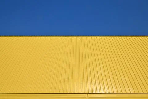 Pattern Yellow Galvanized Metal Profile Against the Sky 스톡 사진
