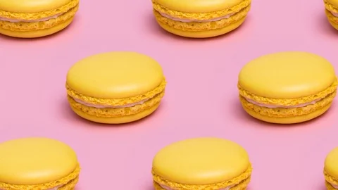 Pattern with yellow macaron cookies on a pink background. Video stock 122303129