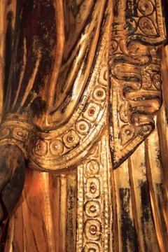 Pattern on the yellow robe of a Buddha statue Stock Photos