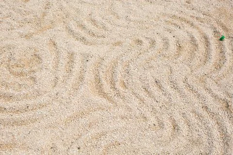 A pattern on the yellow sand of a round shape on the shore Stock Photos