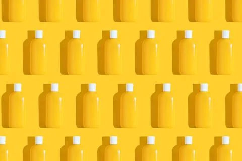 Pattern of yellow tubes of sunscreen on bright yellow background with hard Stock Photos