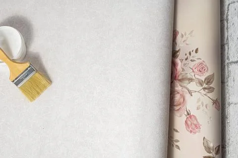 Patterned and patternless paper wallpapers, brush and glue are prepared for r Stock Photos