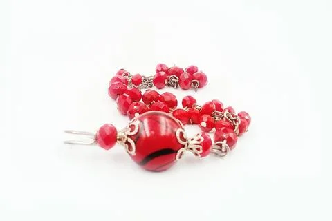 Patterned beaded bracelet, red color, associated with silver color metal Stock Photos