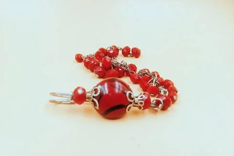 Patterned beaded bracelet, red color, associated with silver color metal Stock Photos