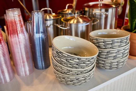 Patterned Ceramic Bowls and Plastic Cups Stack at Vietnamese Cafe Counter Stock Photos