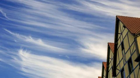 Patterned clouds on a blue sky over a fishing village in the city of Kalining Stock Photos