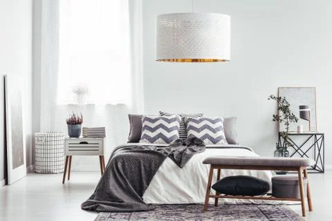 Patterned cushions in bright bedroom Stock-Fotos