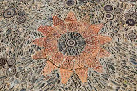 Patterned floor with pattern from pebbles bricks and gears Stock Photos