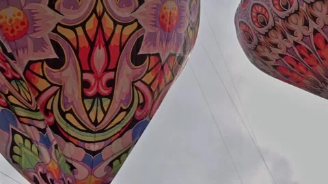 Patterned hot air balloons flying in the sky Stock Footage 255119318