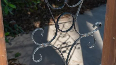 Patterned lattice casts a shadow on the ground in the form of a pattern, forg Stock Photos