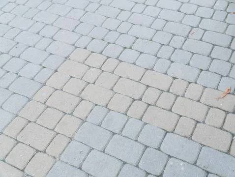 A Patterned Mosaic of Textured Pavers in Subtle Earthy Tones Stockfoto's