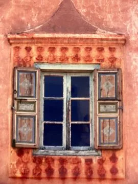 Patterned orange facade with rustic window, Marrakesh, Morocco Stock Photos