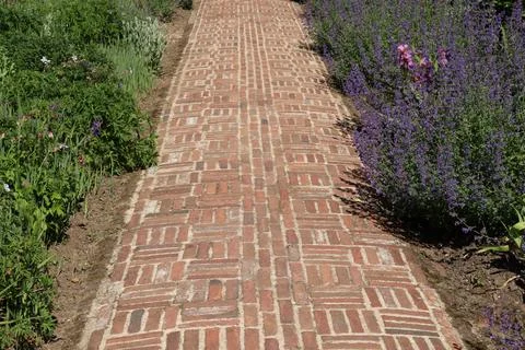 A patterned path formed out of old bricks in the stable area of an old Englis 스톡 사진