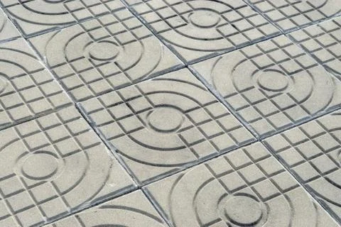 Patterned paving tiles, cement brick floor background Stock Photos