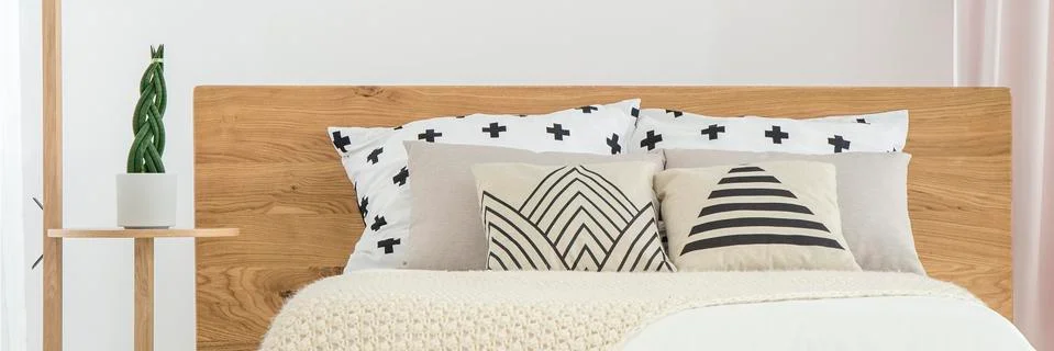 Patterned pillows on bed Stock-Fotos