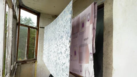 Patterned sheets hanging to dry inside an old enclosed balcony  Stock-Footage 347515197