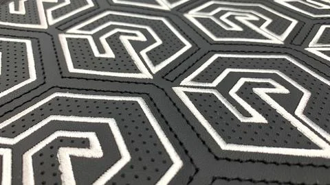 Patterned stitching, embroidery and perforations on black leather Stock Photos