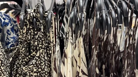 Patterned Summer Dresses Hanging Neatly on Retail Store Rack 스톡 동영상 336320126