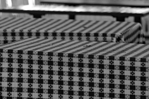 Patterned tablecloths cover empty outdoor dining tables in Long Beach. Stock Photos