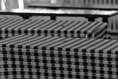 Patterned tablecloths cover empty outdoor dining tables in Long Beach. Stock Photos