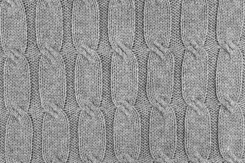 Patterned wool yarn, single-toned gray warm knitted texture. Stock Photos