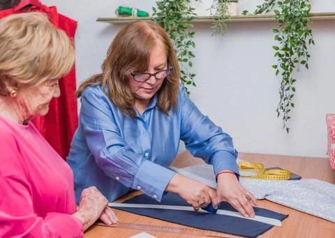 Patternmaking seamstress making a handmade dress. clothes manufacturing. mature Stock Photos