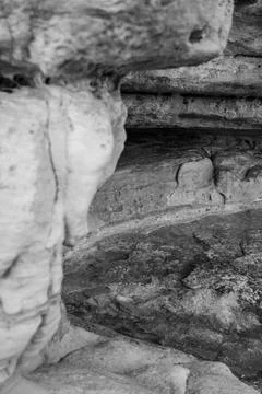 Patterns and textures of a rock wall with holes, black and white Stock Photos