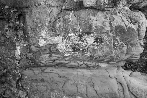 Patterns and textures of a rock wall with holes, black and white Stock Photos