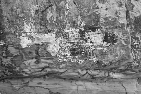 Patterns and textures of a rock wall with holes, black and white Stock Photos