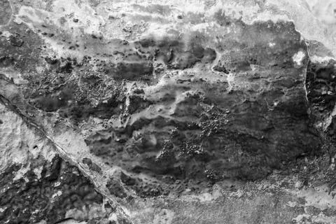 Patterns and textures of a rock wall with holes, black and white Stock Photos