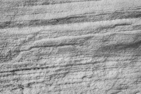 Patterns and textures of a rock wall with holes, black and white Stock Photos