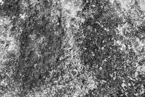 Patterns and textures of a rock wall with holes, black and white Stock Photos