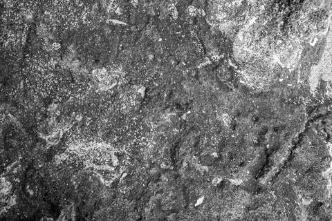 Patterns and textures of a rock wall with holes, black and white Stock Photos