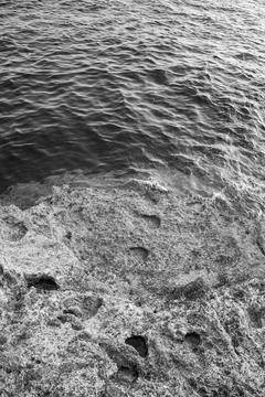 Patterns and textures of a rock wall with holes, black and white Stock Photos