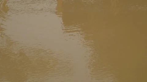 Patterns and textures Small ripples in murky brown pool water Stock Footage 291601754