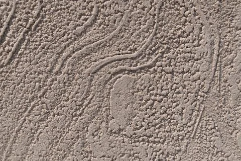Patterns on a beige concrete wall. Rough surface. Background Stock Photos
