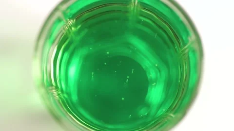 The patterns of bubbles in a green soda Stock Footage 134908375