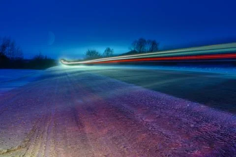 Patterns from car headlights on the night winter highway in the form of white Stock Photos