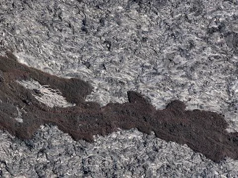 Patterns cracks and shapes from close up portion of black solidified lava Stock Photos