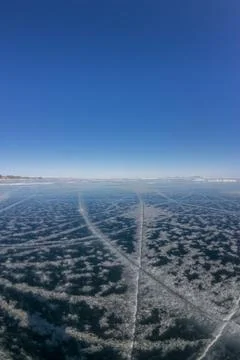 Patterns of cracks on a blue winter ice of Lake Baikal from Olkhon Stock Photos