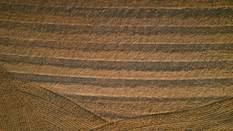 Patterns created on the soil of a freshly plowed field from an aerial Stock Footage 288459733