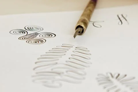Patterns drawn with an ink pen on a white paper sheet with stripes drawn. sta 스톡 사진