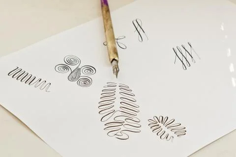 Patterns drawn with an ink pen on a white paper sheet with stripes drawn. sta 스톡 사진