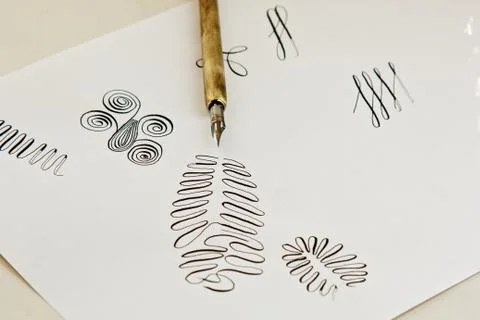 Patterns drawn with an ink pen on a white paper sheet with stripes drawn. sta 스톡 사진