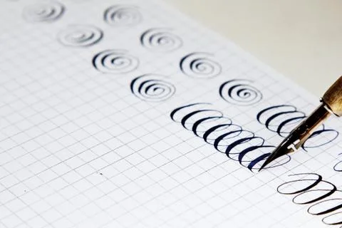 Patterns drawn with an ink pen on a white paper sheet with stripes drawn. sta 스톡 사진