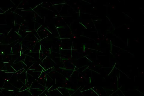 Patterns in green on the wall. Laser background. Party or disco concept. Stock Photos